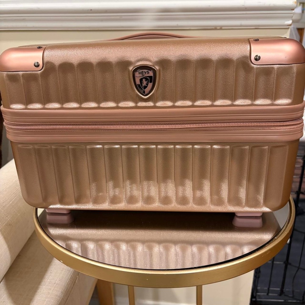 HEYS rose gold hard shell suitcase with vertical ribbed texture